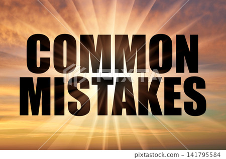 Common mistakes phrase on a beautiful golden evening sunset sky with sun Common mistakes phrase on a beautiful golden evening sunset sky with sun 141795584
