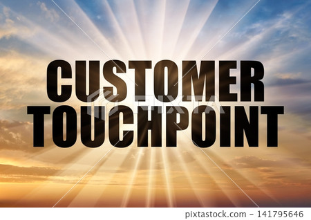 Customer touchpoint text against bright sun rays in morning sky 141795646