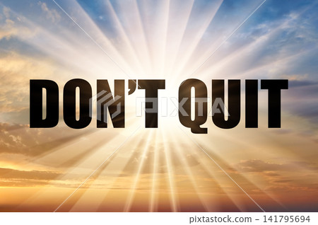 Don't quit text against bright sun rays in morning sky Don't quit text against bright sun rays in morning sky 141795694