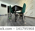 In the kitchen, there is a table with green chairs. Side view, from below. 141795968