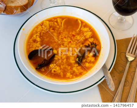 Seafood rice broth with wine and bread Seafood rice broth with wine and bread 141796457
