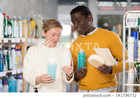 Couple man and woman choosing shampoo or shower gel and washcloth Couple man and woman choosing shampoo or shower gel and washcloth 141796732