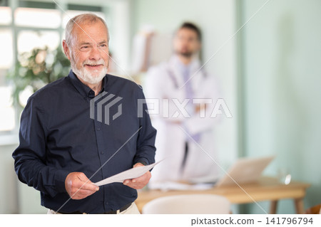 Elderly male patient leaving medical office with test results Elderly male patient leaving medical office with test results 141796794