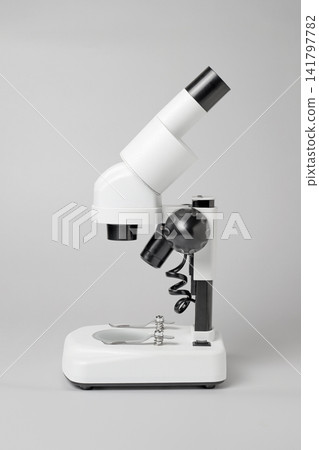 Stereomicroscope placed against a white background Stereomicroscope placed against a white background 141797782