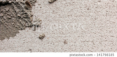 Rough beige concrete wall texture with cement patches 141798185
