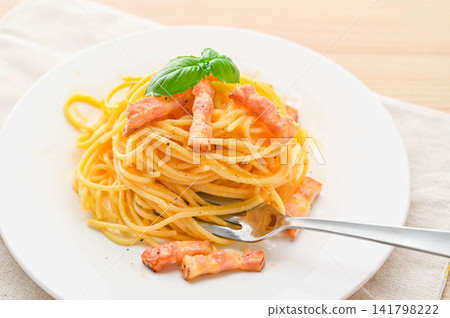 Rich carbonara with thick-cut bacon and basil Rich carbonara with thick-cut bacon and basil 141798222