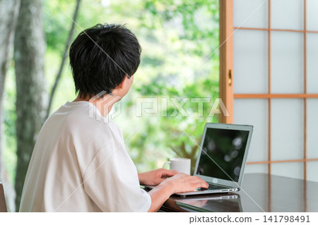 A young man who is an address hopper and does workation/remote work. A young man who is an address hopper and does workation/remote work. 141798491