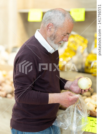 Pensioner in a supermarket is standing in the department with vegetables Pensioner in a supermarket is standing in the department with vegetables 141798551