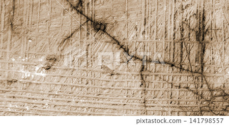Concrete texture with warm sepia tones, featuring diagonal cracks and a grid-line pattern. 141798557