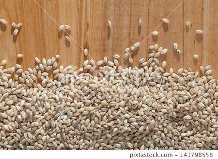 Pearl barley on wooden surface Pearl barley on wooden surface 141798558