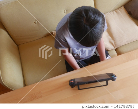 A child playing a game (taken from above) A child playing a game (taken from above) 141798795