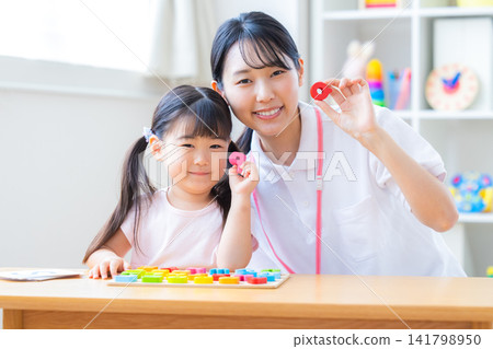 Early childhood education Girls taking lessons in an English conversation class Early childhood education Girls taking lessons in an English conversation class 141798950