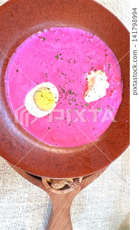 beetroot soup served in a ceramic bowl on a vibrant pink and white textured tablecloth, top-down view, delicious and vibrant food photography, culinary arts, healthy eating. beetroot soup served in a ceramic bowl on a vibrant pink and white textured tablecloth, top-down view, delicious and vibrant food photography, culinary arts, healthy eating. 141798994