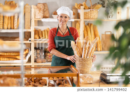 Portrait of positive woman bakery worker Portrait of positive woman bakery worker 141799402
