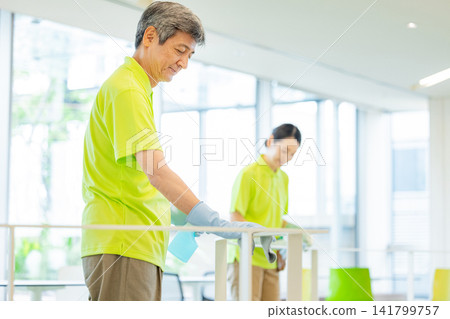 Senior male and female staff cleaning the office Senior male and female staff cleaning the office 141799757
