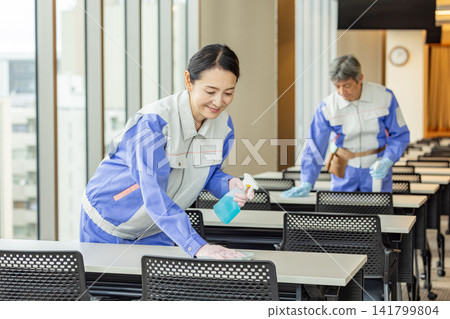 Cleaning staff clean the office meeting rooms. Cleaning staff clean the office meeting rooms. 141799804