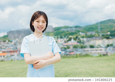 A young female nurse holding a chart A young female nurse holding a chart 141800225