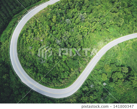 Aerial view forest nature with car on the road on the mountain green tree top view road curve Aerial view forest nature with car on the road on the mountain green tree top view road curve 141800347