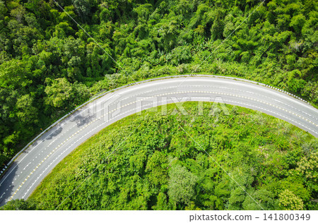 Aerial view forest nature with car on the road on the mountain green tree top view road curve Aerial view forest nature with car on the road on the mountain green tree top view road curve 141800349