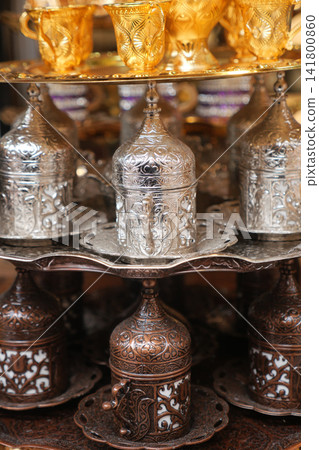Decorative metal cups and containers displayed for sale Decorative metal cups and containers displayed for sale 141800860