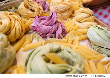 Different types of pasta displayed on a wooden tray 141800879