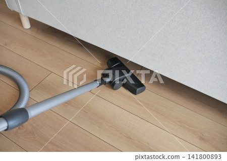 Vacuum cleaner in living room corner Vacuum cleaner in living room corner 141800893
