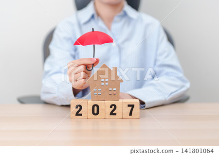 Happy New Year 2027 with red umbrella over money stack. Insurance, real estate, Home loan, tax, investment, mortgage, financial, savings, protection and safety Happy New Year 2027 with red umbrella over money stack. Insurance, real estate, Home loan, tax, investment, mortgage, financial, savings, protection and safety 141801064