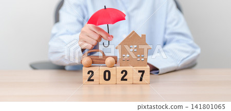 Happy New Year 2027 with red umbrella. Insurance, real estate, Home, car, loan, tax, investment, mortgage, financial, savings, protection and safety 141801065