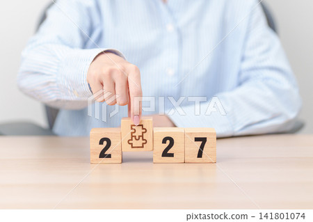 2027 year block with jigsaw puzzle icon. Business Process, Team, teamwork, Goal, mission, Resolution, strategy, plan, Action, partnership, and New Year start 141801074