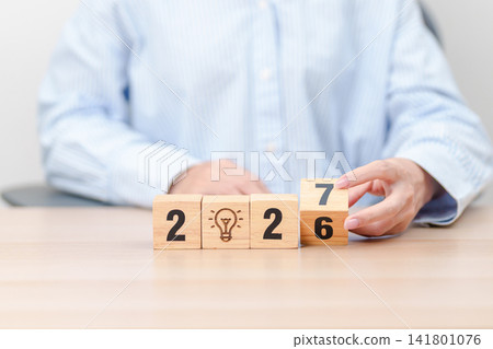 2026 year change to 2027 year block with lightbulb. Business Idea, Creative, Thinking, brainstorm, Goal, Resolution, strategy, plan, Action, change and New Year start concepts 2026 year change to 2027 year block with lightbulb. Business Idea, Creative, Thinking, brainstorm, Goal, Resolution, strategy, plan, Action, change and New Year start concepts 141801076