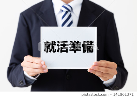A young businessman in a business suit holding a whiteboard for job hunting preparations. A young businessman in a business suit holding a whiteboard for job hunting preparations. 141801371
