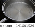 The stainless steel frying pan is almost preheated. 141801529