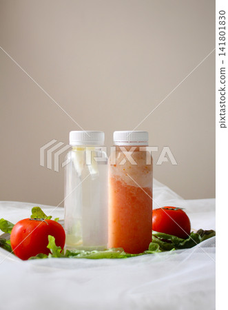 Two Bottles of Fresh Tomato Juice with Tomatoes and Lettuce for Healthy Beverage, Food Packaging and Nutrition Concept, beverage packaging, food branding, restaurant menus, recipe books Two Bottles of Fresh Tomato Juice with Tomatoes and Lettuce for Healthy Beverage, Food Packaging and Nutrition Concept, beverage packaging, food branding, restaurant menus, recipe books 141801830