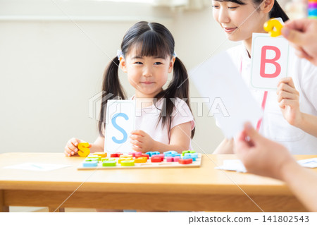 Early childhood education Girls taking lessons in an English conversation class Early childhood education Girls taking lessons in an English conversation class 141802543