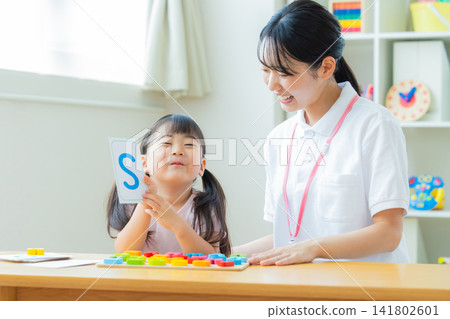 Early childhood education Girls taking lessons in an English conversation class Early childhood education Girls taking lessons in an English conversation class 141802601