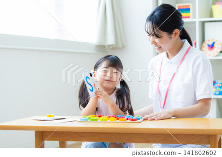 Early childhood education Girls taking lessons in an English conversation class Early childhood education Girls taking lessons in an English conversation class 141802602