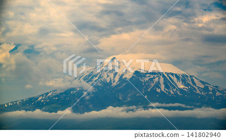Dramatic mountain peak covered in snow Dramatic mountain peak covered in snow 141802940