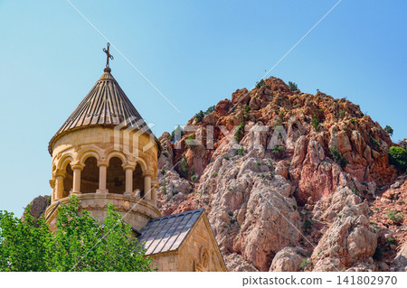 Historic church Noravank perched on rocky hillside under bright sky Historic church Noravank perched on rocky hillside under bright sky 141802970