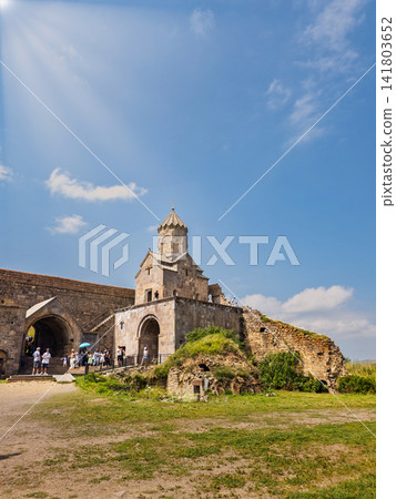 Armenian Tatev monastery with visitors exploring ancient stone walls on sunny da Armenian Tatev monastery with visitors exploring ancient stone walls on sunny da 141803652