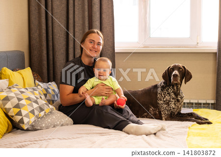 Mother and Baby Pose Beside German Shorthaired Pointer 141803872
