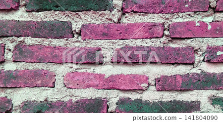 Weathered brick wall in bright pink and dark magenta. Weathered brick wall in bright pink and dark magenta. 141804090