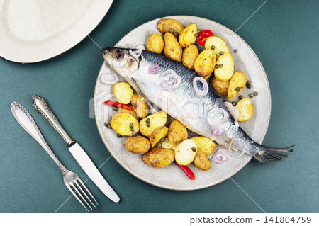 Salted herring with potatoes, onion and herbs Salted herring with potatoes, onion and herbs 141804759