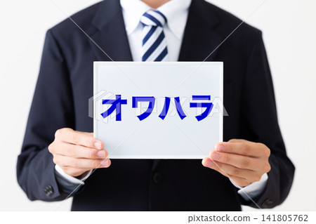 A young businessman in a business suit holding a whiteboard with the words "Owahara" (job-hunting harassment) on it. A young businessman in a business suit holding a whiteboard with the words "Owahara" (job-hunting harassment) on it. 141805762