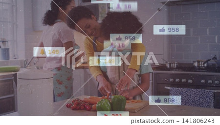 Woman wearing apron guiding child chopping vegetables on island with knife, peppers, social icons Woman wearing apron guiding child chopping vegetables on island with knife, peppers, social icons 141806243