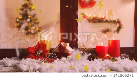 Showing holiday display on wooden windowsill, with pillar candles, poinsettia, small house Showing holiday display on wooden windowsill, with pillar candles, poinsettia, small house 141806271