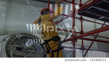 Climbing tech wearing yellow suit, orange hardhat, reaching scaffold beside rotor, wearing harness Climbing tech wearing yellow suit, orange hardhat, reaching scaffold beside rotor, wearing harness 141806315
