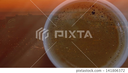Displaying cup of coffee reflecting sunset skyline at window, showing crema and dark bubble Displaying cup of coffee reflecting sunset skyline at window, showing crema and dark bubble 141806372