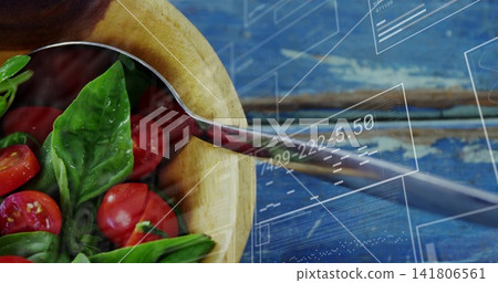 Showing wooden bowl holding basil and halved tomatoes on worn blue table, reflecting spoon and HUD Showing wooden bowl holding basil and halved tomatoes on worn blue table, reflecting spoon and HUD 141806561
