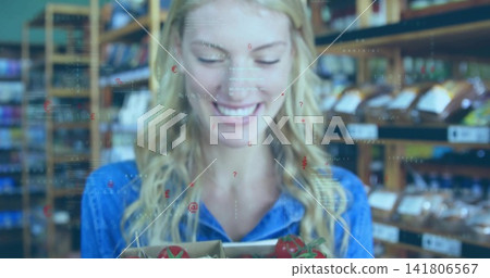Holding woman wearing denim shirt, examining crate of ripe tomatoes in grocery aisle, with overlays Holding woman wearing denim shirt, examining crate of ripe tomatoes in grocery aisle, with overlays 141806567