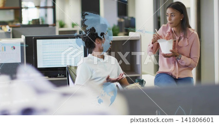 Talking man in white polo and woman in pink blouse sitting near monitors, holding takeout Talking man in white polo and woman in pink blouse sitting near monitors, holding takeout 141806601